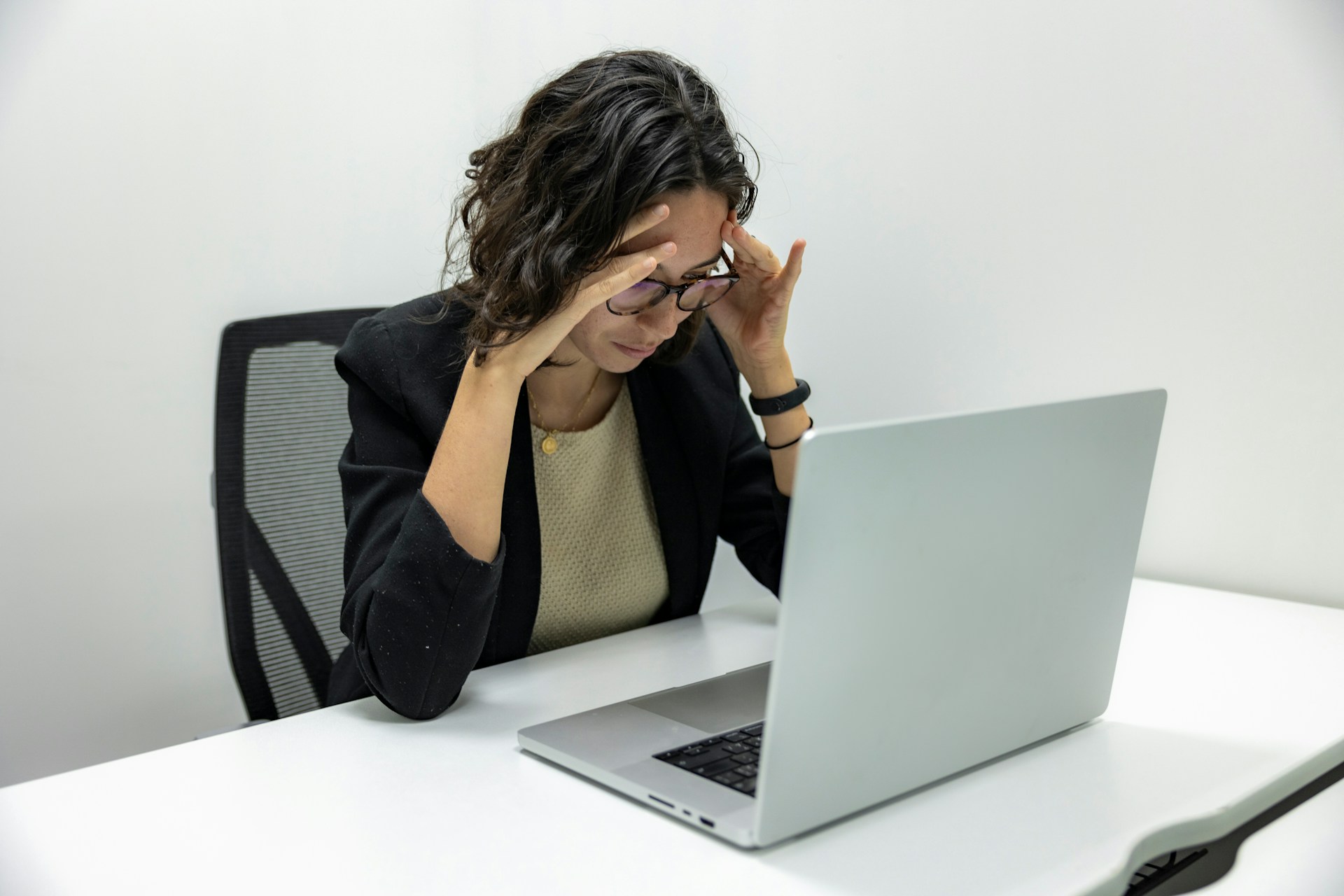 Professional woman frustrated in front of laptop
