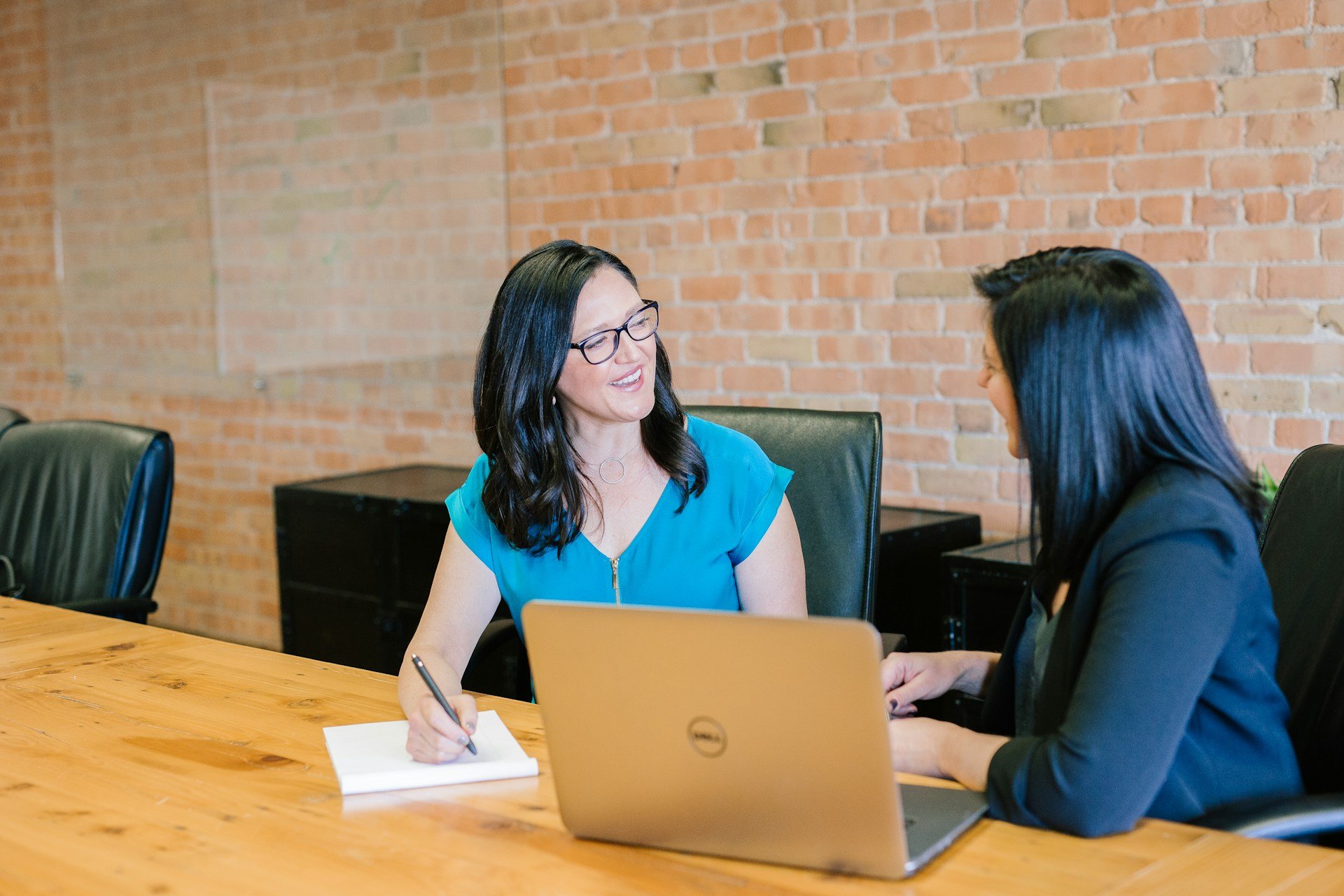 Woman providing financial service advice with a laptop open in front of her